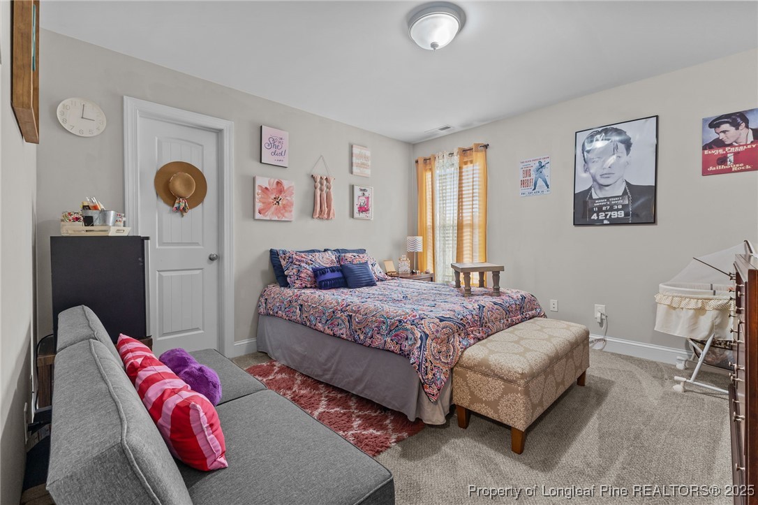 160 Huzzas Circle Cameron, NC 28326 - Photo 13 of 34 a bedroom with a bed and painting on the wall