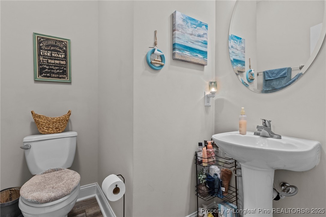160 Huzzas Circle Cameron, NC 28326 - Photo 17 of 34 a bathroom with a toilet sink and mirror