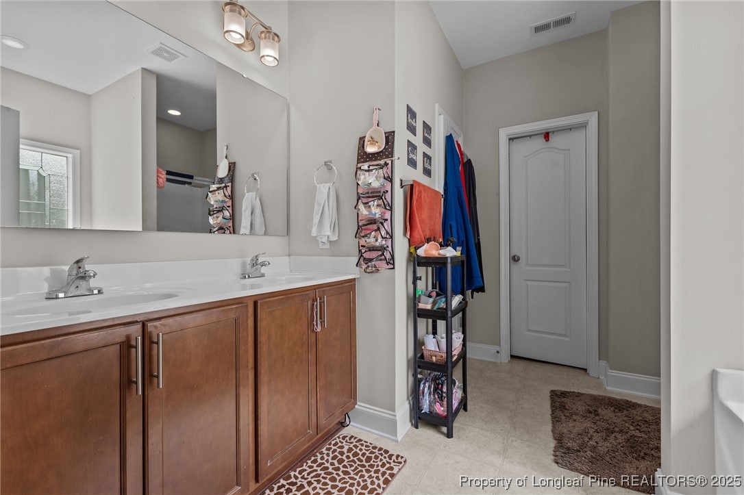 160 Huzzas Circle Cameron, NC 28326 - Photo 19 of 34 a bathroom with a sink a mirror and shower