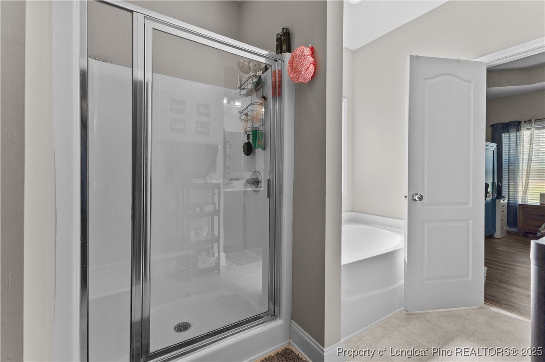 160 Huzzas Circle Cameron, NC 28326 - Photo 21 of 34 a bathroom with a glass shower door