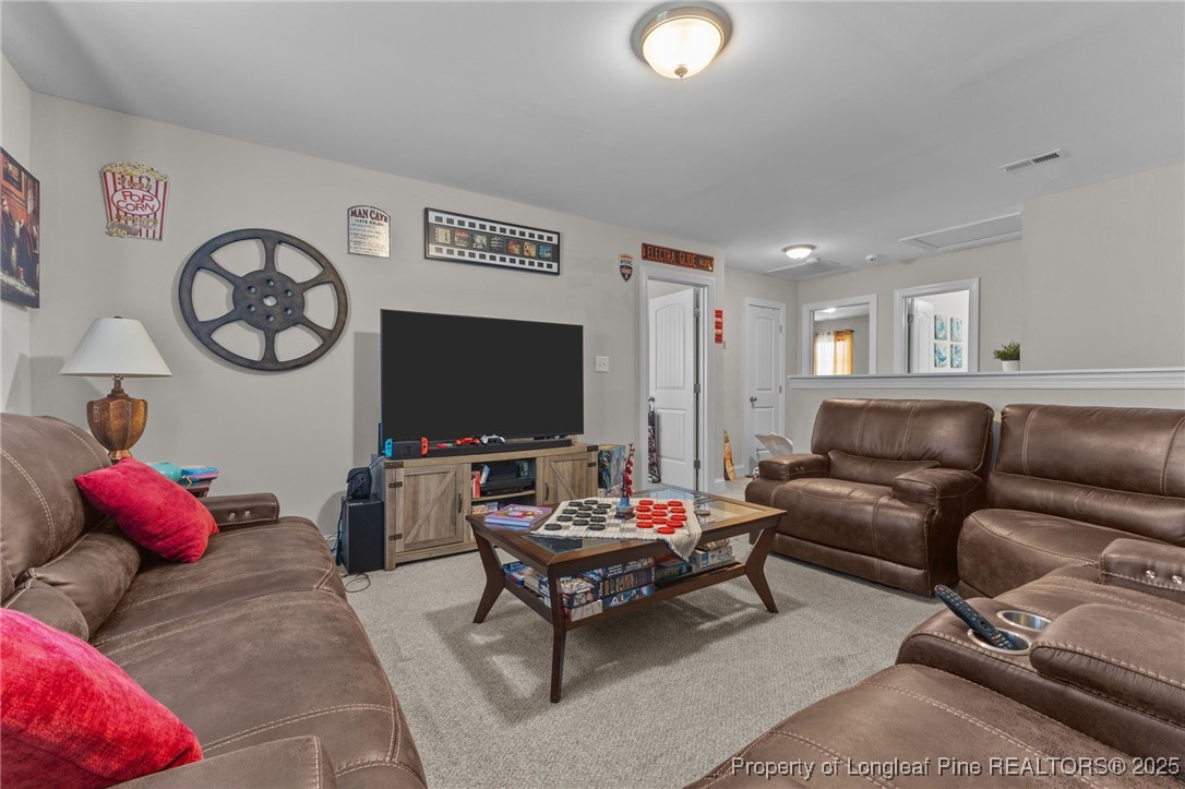 160 Huzzas Circle Cameron, NC 28326 - Photo 23 of 34 a living room with furniture and a flat screen tv