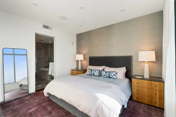 a bathroom with a double vanity sink a large mirror and shower