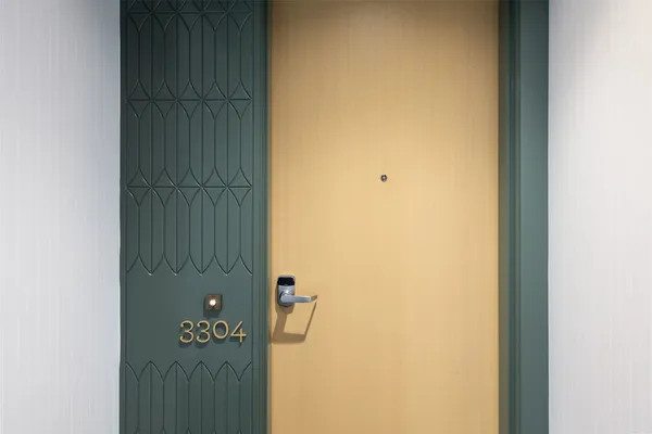 a bedroom with a large window and a bed