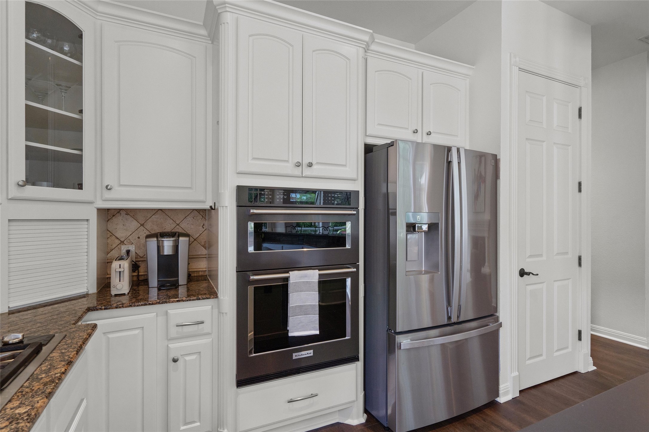 4313 Rio Robles Drive Austin, TX 78746 - Photo 16 of 40 A well-appointed kitchen features abundant white cabinetry and integrated stainless steel appliances.