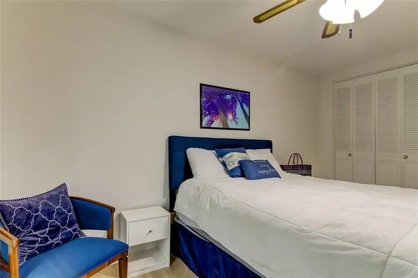 a dining hall with stainless steel appliances granite countertop a stove a sink a refrigerator and island with wooden floor