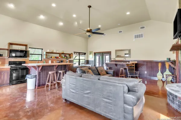 a living room with furniture a fireplace and a flat screen tv