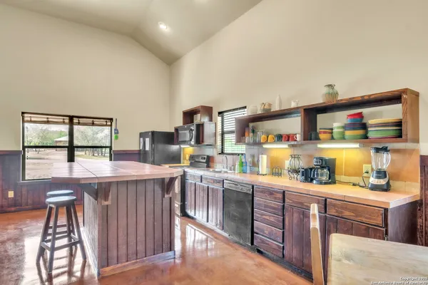 a kitchen with stainless steel appliances granite countertop a sink and cabinets