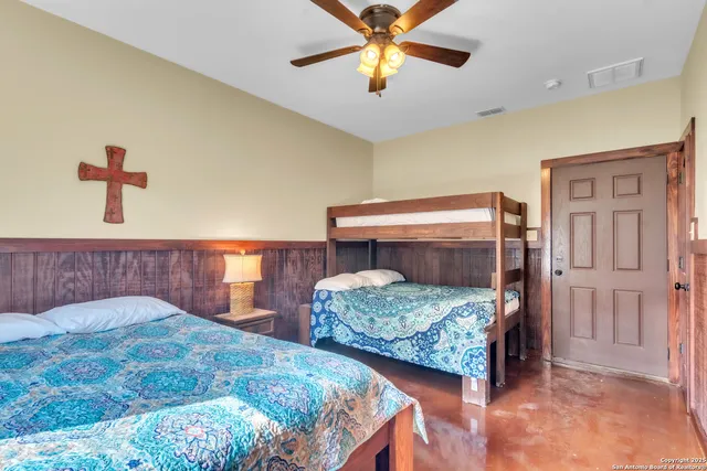 a bedroom with two beds and a chandelier