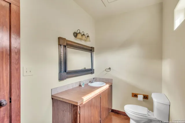 a bedroom with two beds and a chandelier