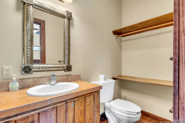 a bathroom with a sink vanity and a mirror