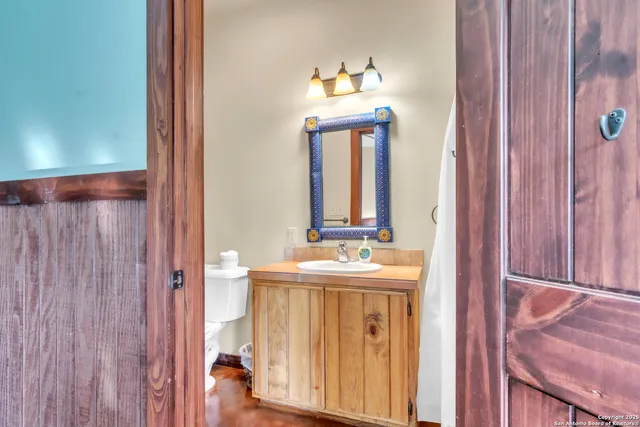 a bedroom with two beds and painting on the wall