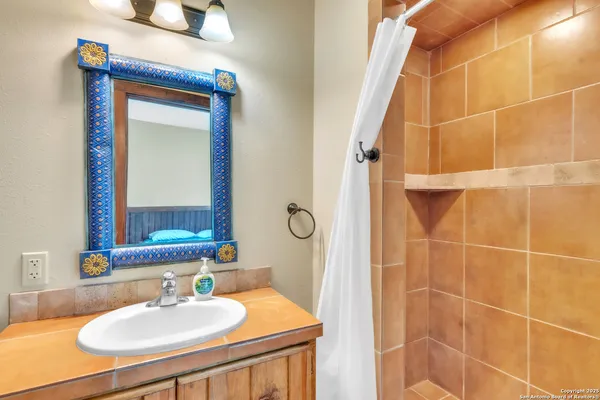 a bathroom with a sink vanity and a mirror