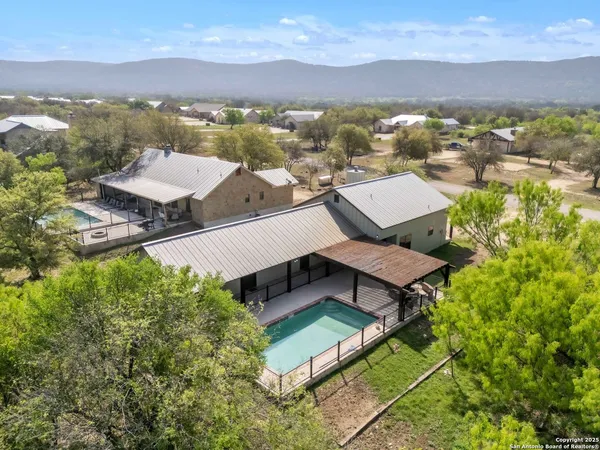 an aerial view of a house with pool patio and lake view