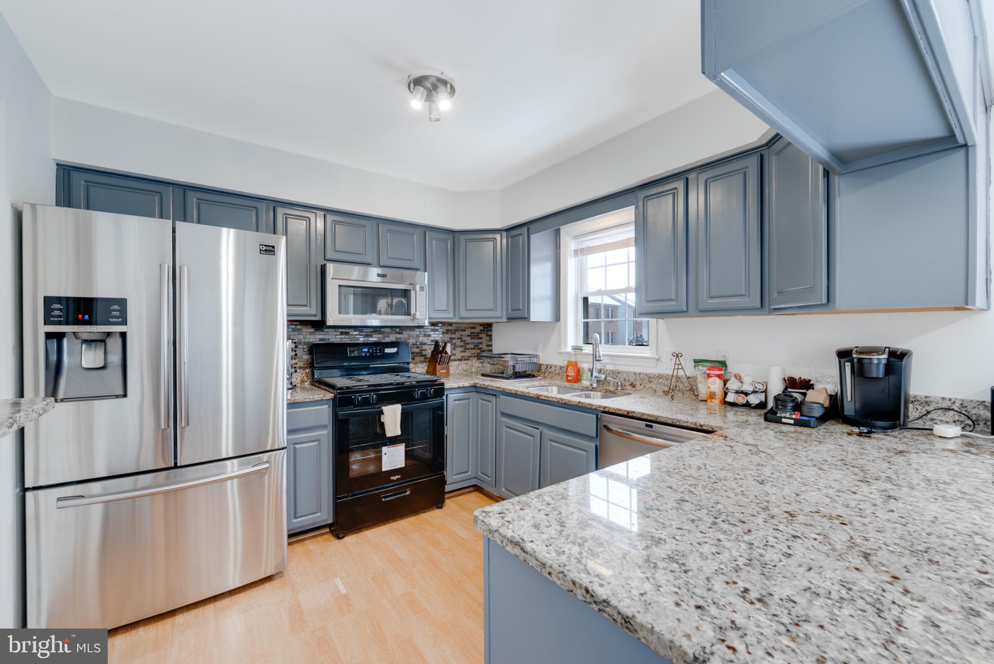2 Knox Circle Southeast Washington, DC 20020 - Photo 11 of 25 a kitchen with refrigerator a microwave a sink and cabinets