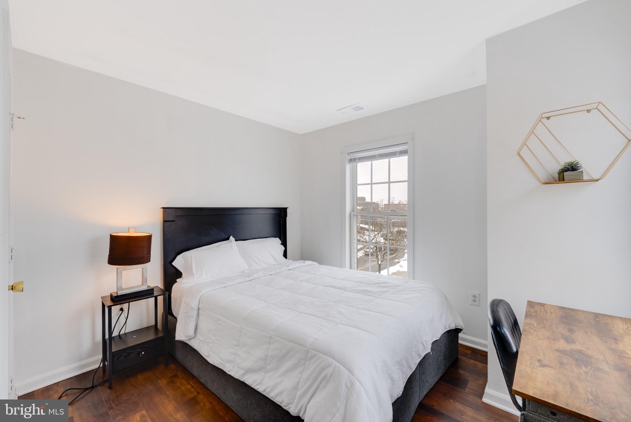 2 Knox Circle Southeast Washington, DC 20020 - Photo 18 of 25 a bedroom with a bed and wooden floor