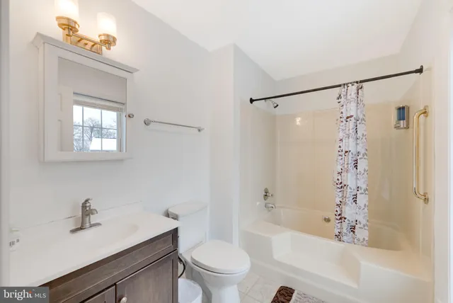 a white bath tub sitting next to a white toilet