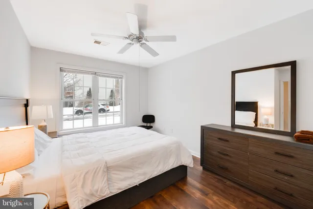 a bedroom with a large bed and a window