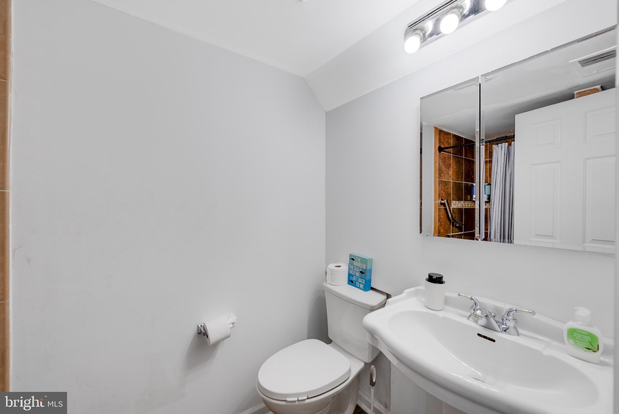 2 Knox Circle Southeast Washington, DC 20020 - Photo 6 of 25 a bathroom with a sink mirror and toilet