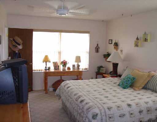 16521 Alexander Run Jupiter, FL 33478 - Photo 12 of 15 a bedroom with a bed and a window