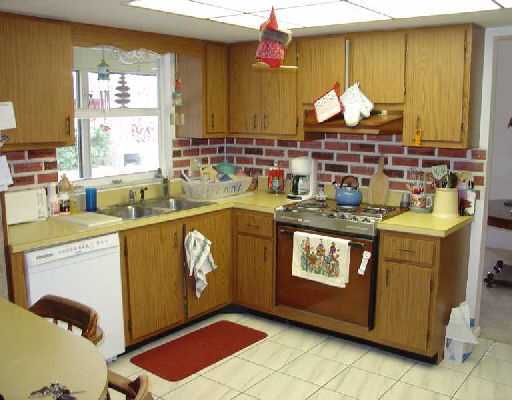 16521 Alexander Run Jupiter, FL 33478 - Photo 13 of 15 a kitchen with stainless steel appliances granite countertop a stove a sink and a microwave