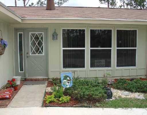 16521 Alexander Run Jupiter, FL 33478 - Photo 2 of 15 a front view of a house