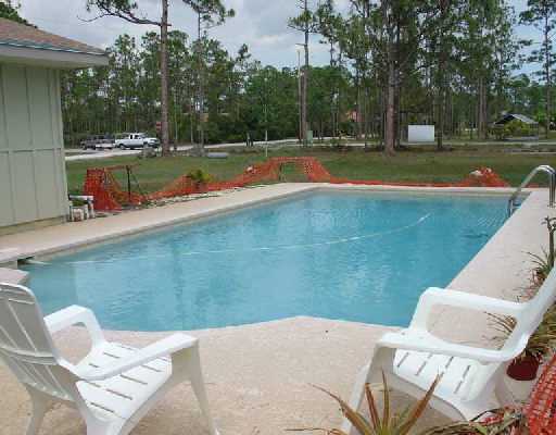 16521 Alexander Run Jupiter, FL 33478 - Photo 4 of 15 a view of a backyard with swimming pool