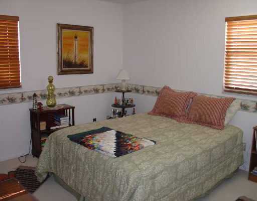 16521 Alexander Run Jupiter, FL 33478 - Photo 10 of 15 a bedroom with a bed and a table