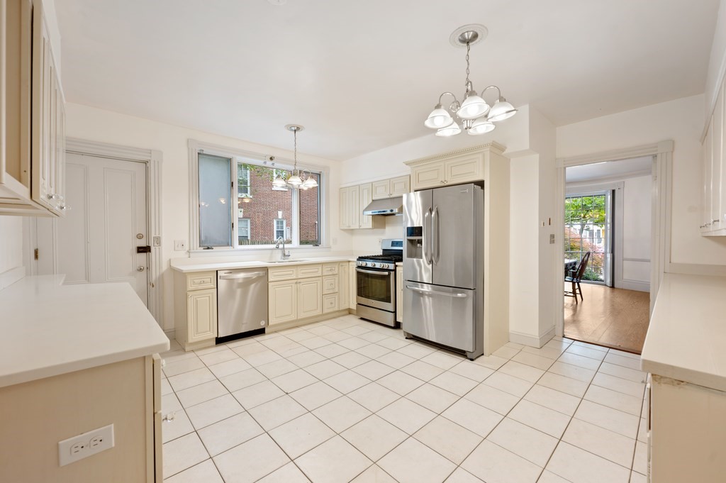 29 Follen Street Cambridge, MA 02138 - Photo 11 of 32 a kitchen with a sink refrigerator and microwave