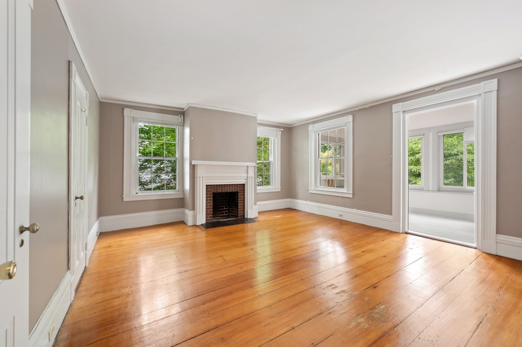 29 Follen Street Cambridge, MA 02138 - Photo 16 of 32 a view of empty room with wooden floor and fireplace