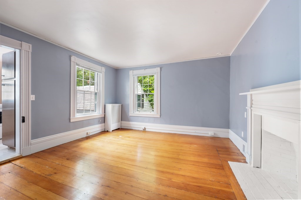 29 Follen Street Cambridge, MA 02138 - Photo 19 of 32 a view of an empty room with window and wooden floor