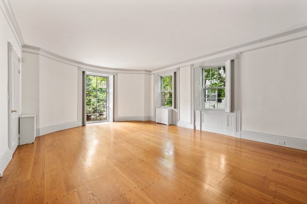 29 Follen Street Cambridge, MA 02138 - Photo 2 of 32 a view of an empty room with wooden floor and a window