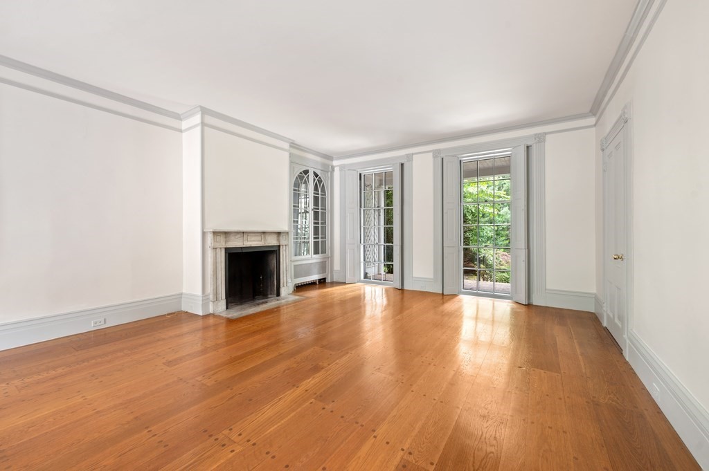 29 Follen Street Cambridge, MA 02138 - Photo 3 of 32 a view of an empty room with wooden floor and a window