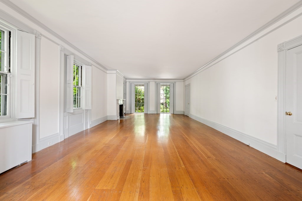 29 Follen Street Cambridge, MA 02138 - Photo 4 of 32 a view of an empty room with wooden floor and a window