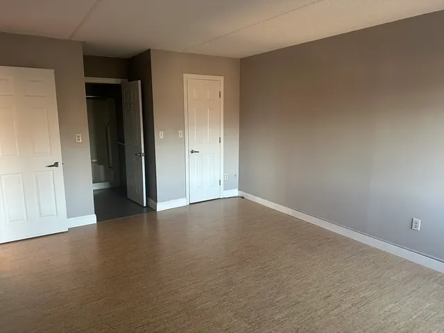 a view of an empty room and closet area