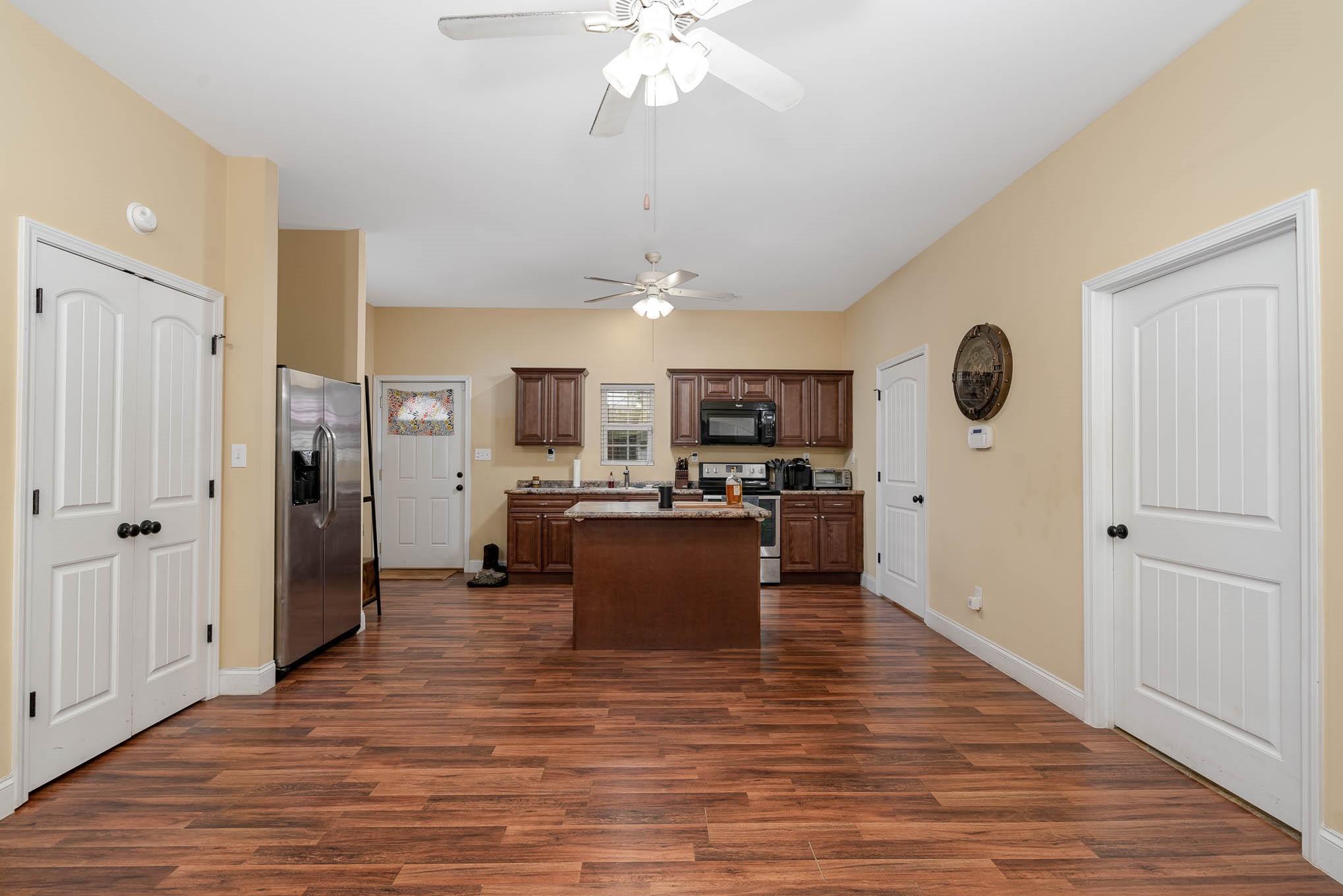740 Shannon Meadow Road Clover, SC 29710 - Photo 13 of 31 a view of kitchen with kitchen island stainless steel appliances refrigerator stove and wooden floor