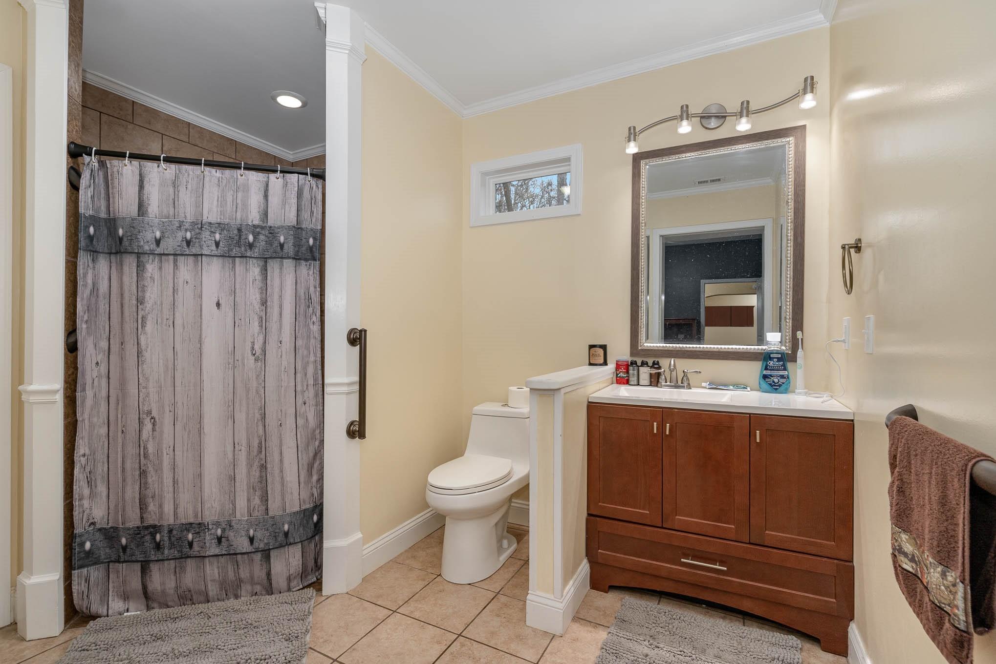 740 Shannon Meadow Road Clover, SC 29710 - Photo 19 of 31 a bathroom with a toilet a sink and mirror