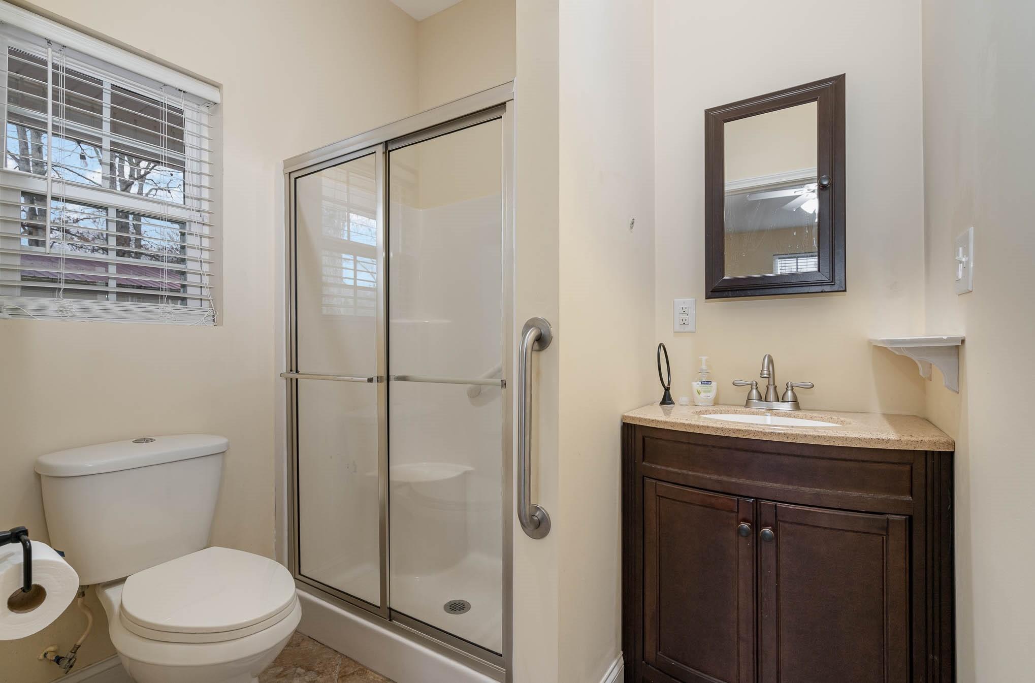 740 Shannon Meadow Road Clover, SC 29710 - Photo 23 of 31 a bathroom with a toilet a sink a mirror a vanity and shower