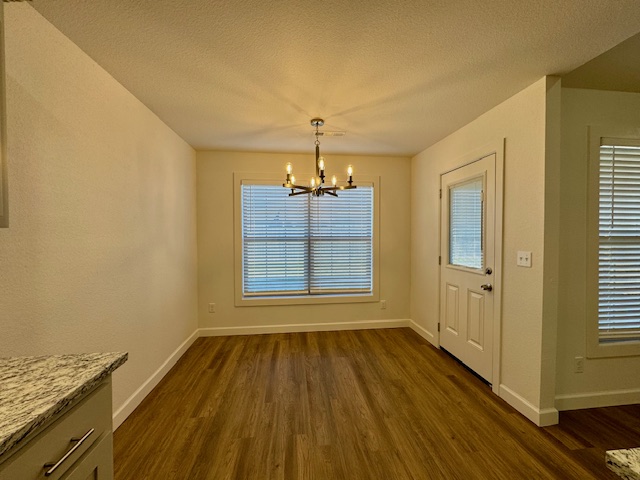 2250 Hunter Drive Pea Ridge, AR 72751 - Photo 10 of 21 Wood-finish flooring, white trim, a modern chandelier, and a window with blinds