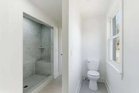 a bathroom with a toilet and a shower
