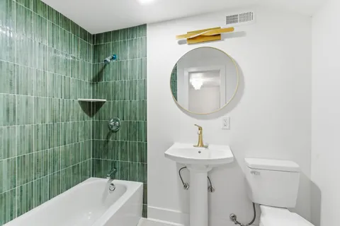 a bathroom with a sink toilet and shower