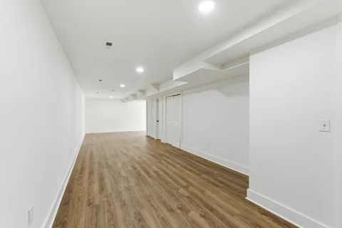 a view of hallway with wooden floor