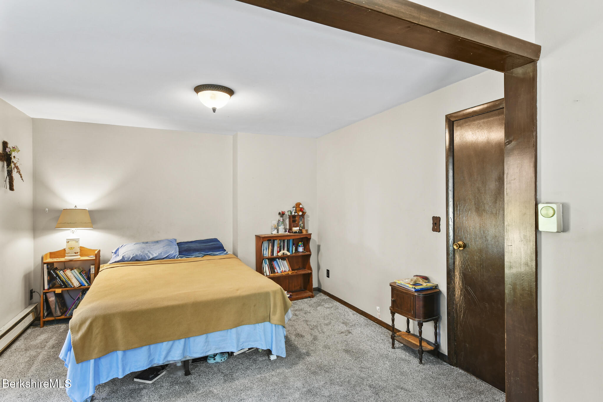 74 Old Main Road Savoy, MA 01256 - Photo 31 of 42 a bedroom with a bed and a mirror