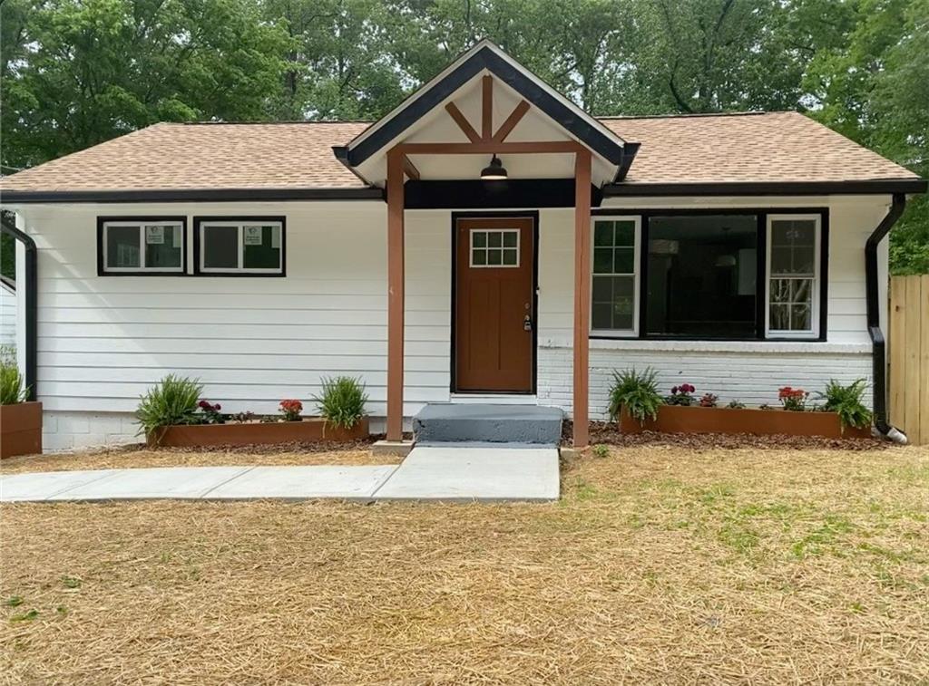 1966 Spink Street Northwest Atlanta, GA 30318 - Photo 1 of 1 a front view of a house with a yard