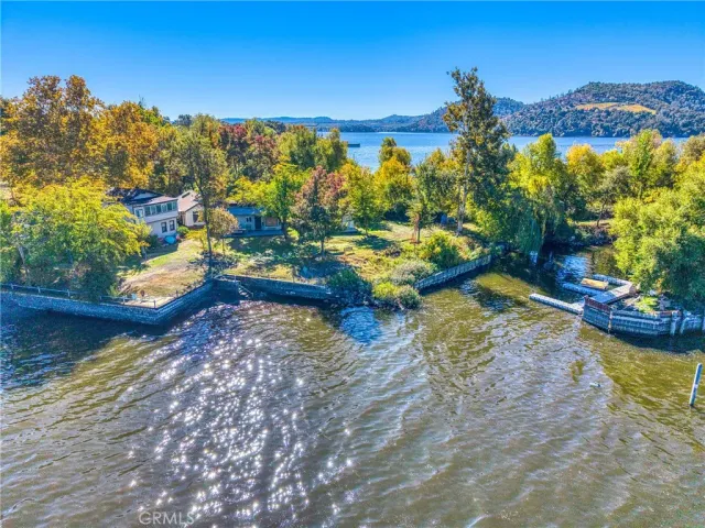 a view of a house with a yard and lake view