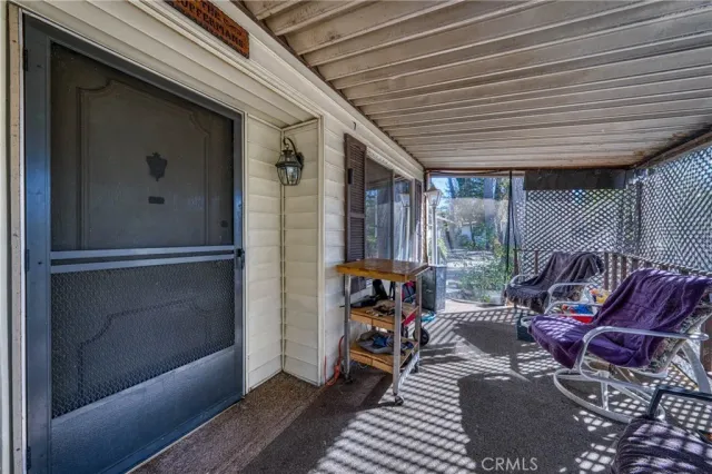 a view of a balcony with furniture and floor to ceiling window