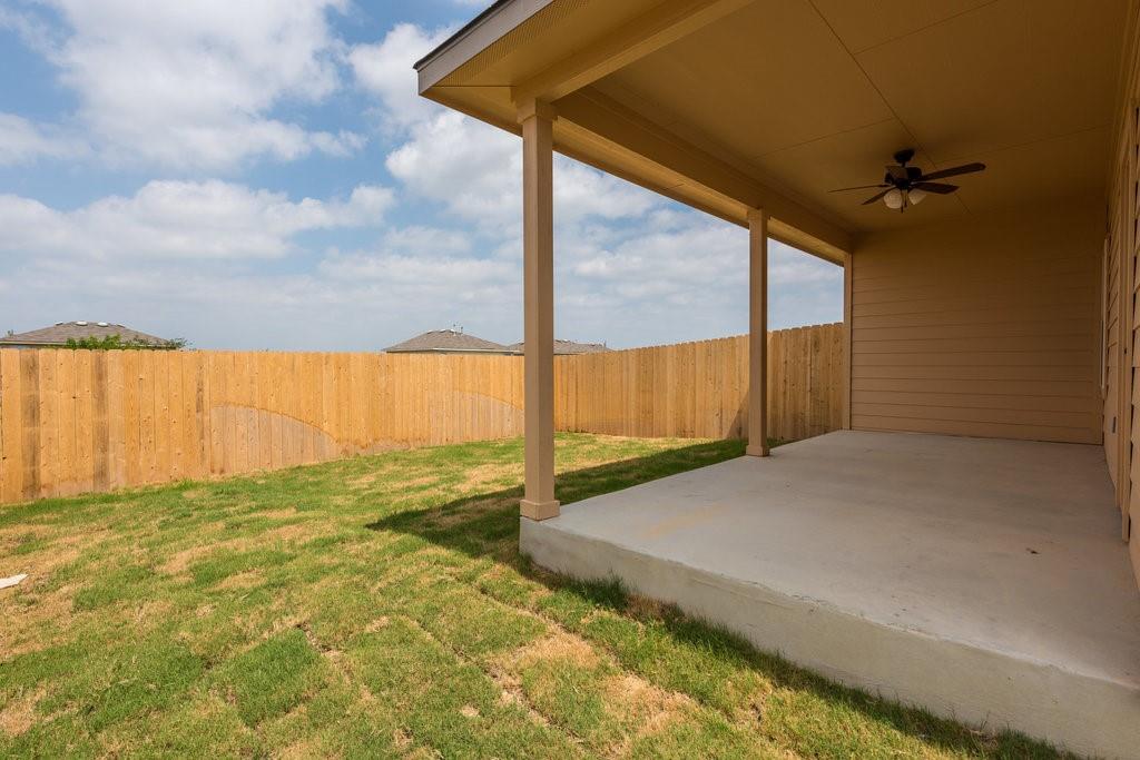 491 Jack Rabbit Lane, Unit A Buda, TX 78610 - Photo 20 of 22 A private, covered patio with verdant lawn space offers ample outdoor enjoyment.
