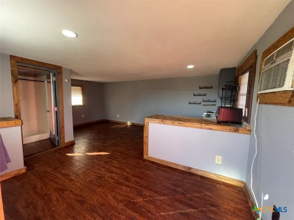 a room with wooden floor and cabinets