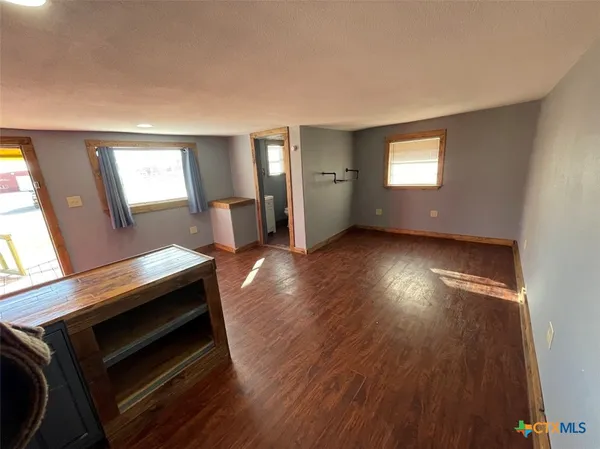 a view of kitchen and hall with wooden floor