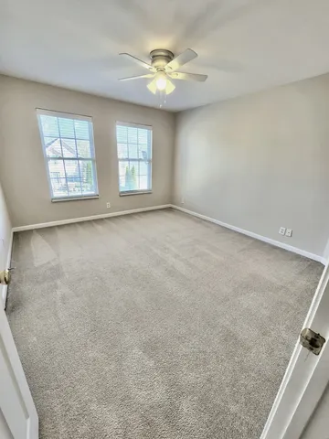 a view of a room with a ceiling fan