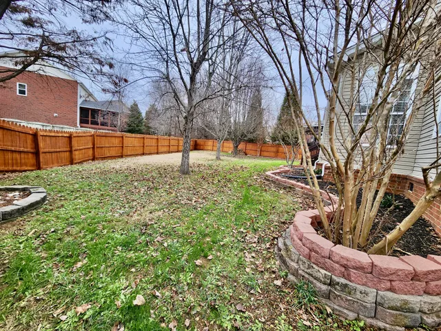 a backyard of a house with barbeque oven